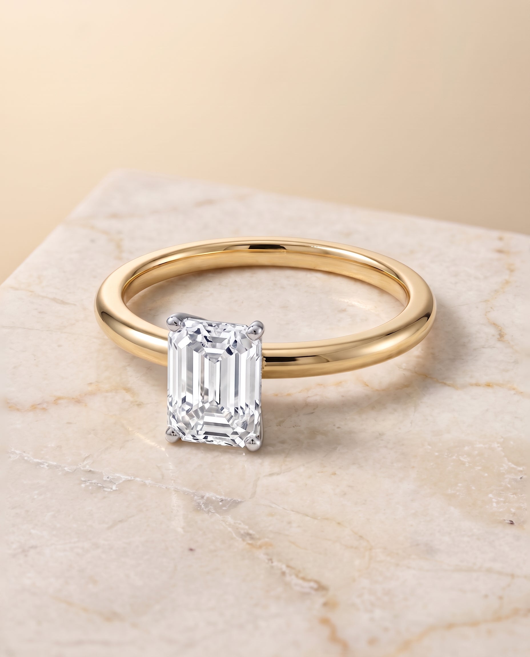 The Floria Comfort Fit Claw Prong Solitaire Emerald Cut Engagement Ring Setting in 18K Yellow Gold