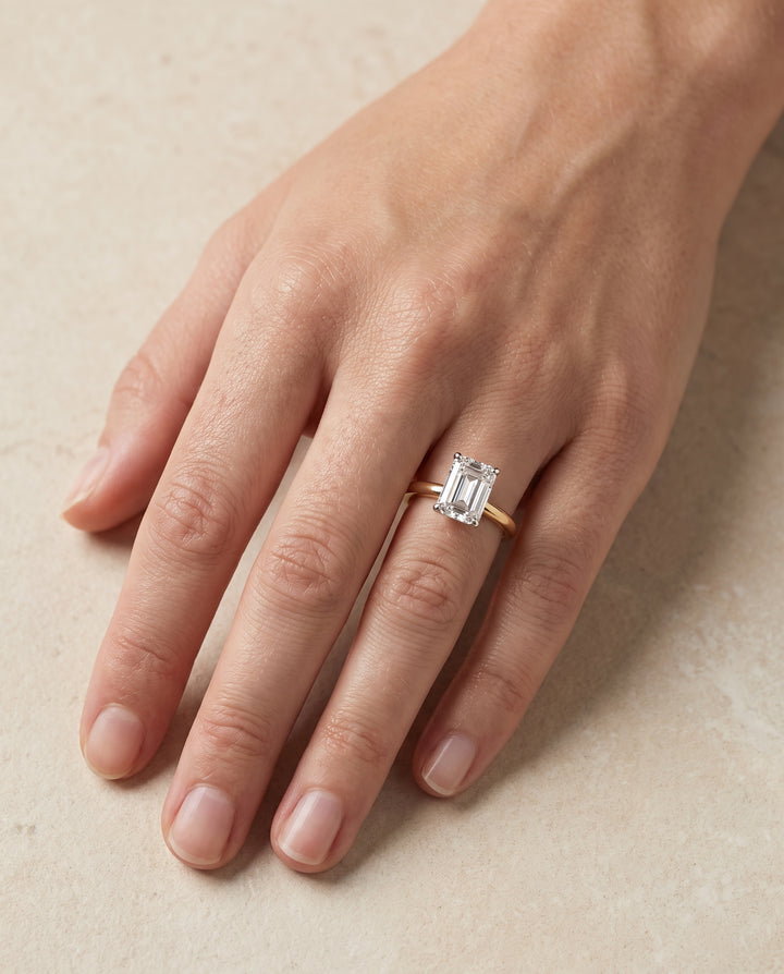 The Floria Comfort Fit Claw Prong Solitaire Emerald Cut Engagement Ring Setting in 18K Yellow Gold