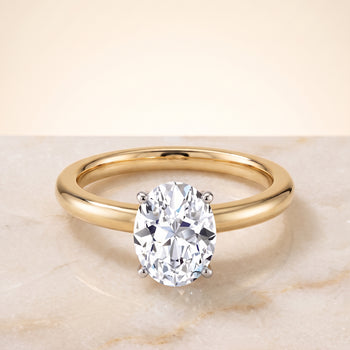 The Floria Comfort Fit Claw Prong Solitaire Oval Engagement Ring Setting in 18K Yellow Gold