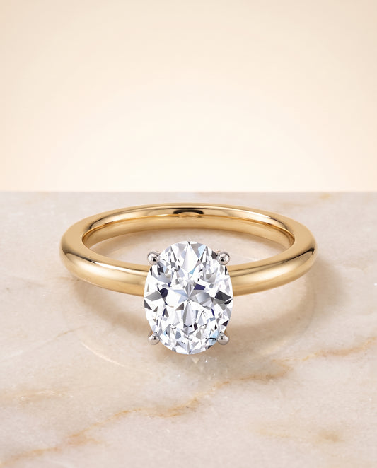 The Floria Comfort Fit Claw Prong Solitaire Oval Engagement Ring Setting in 18K Yellow Gold