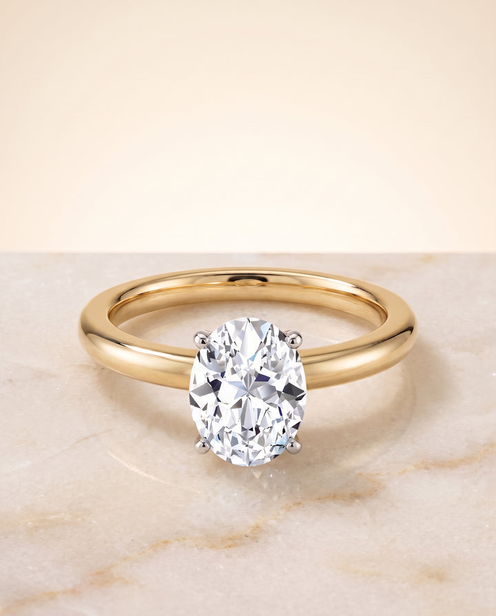 The Floria Comfort Fit Claw Prong Solitaire Oval Engagement Ring Setting in 18K Yellow Gold