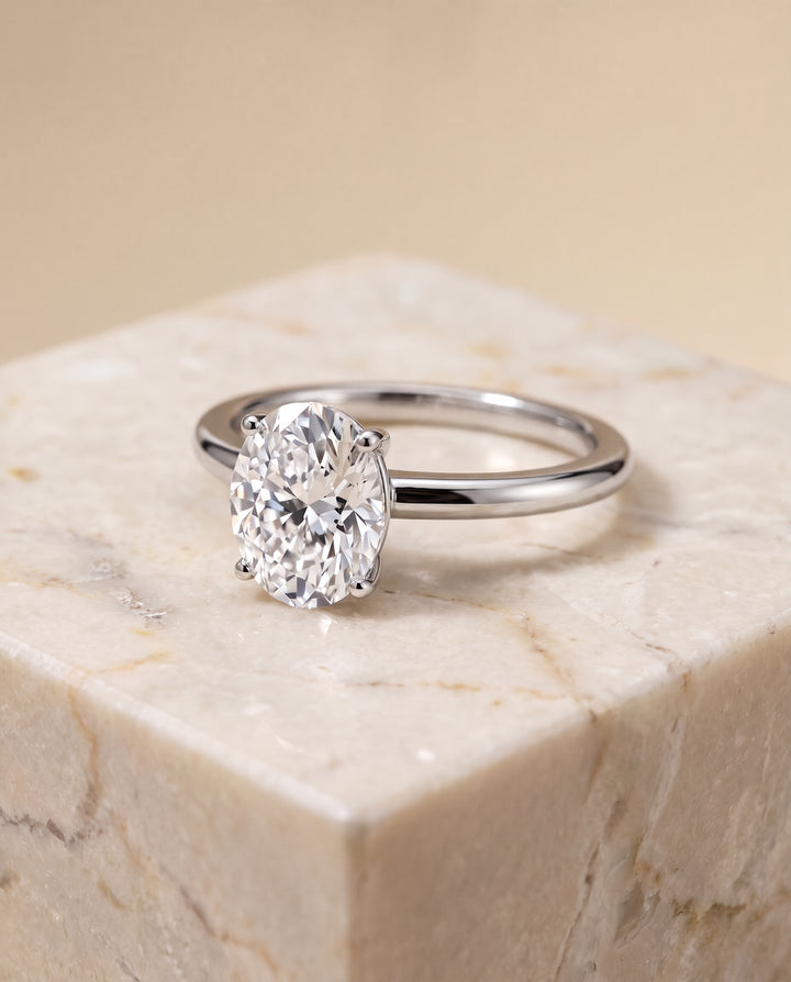 The Floria Comfort Fit Claw Prong Solitaire Oval Engagement Ring Setting in Platinum
