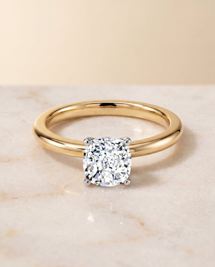 Floria Select Solitaire Cushion Cut Lab Diamond Engagement Ring in 18K Yellow Gold, shown on hand, angled | RockHer