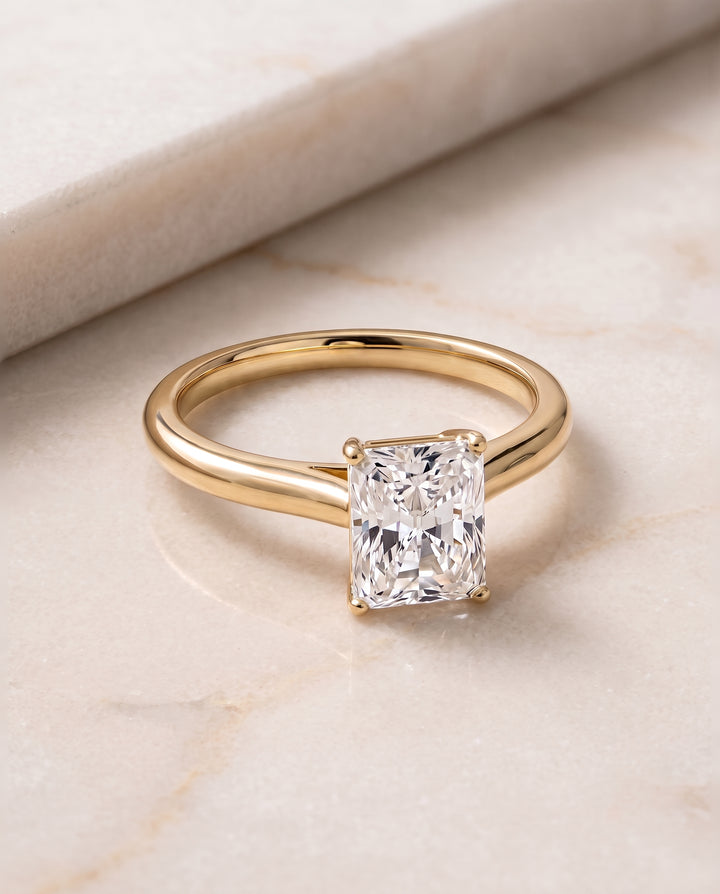The Gladys Pinched Cathedral Solitaire Radiant Cut Engagement Ring Setting in 18K Yellow Gold