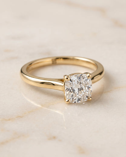 Gladys Select Solitaire Cushion Cut Lab Diamond Engagement Ring in 18K Yellow Gold, shown on hand, angled | RockHer