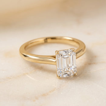 The Gladys Pinched Cathedral Solitaire Emerald Cut Engagement Ring Setting in 18K Yellow Gold