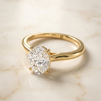 The Gladys Pinched Cathedral Solitaire Oval Engagement Ring Setting in 18K Yellow Gold