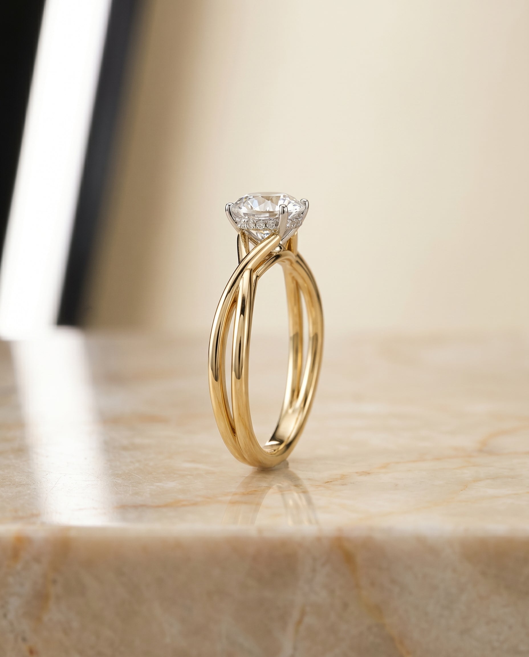 The Grace solitaire engagement ring setting for round diamonds in 18k yellow gold engagement ring setting, shown in precio...