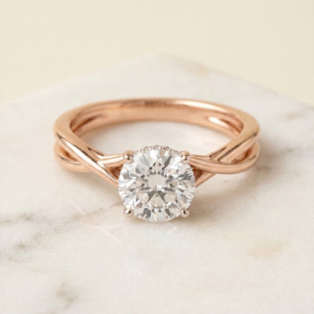 The Grace Twisted Shank Hidden Halo Solitaire Round Engagement Ring Setting in 14K Rose Gold