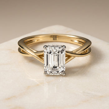 The Grace Twisted Shank Hidden Halo Solitaire Emerald Cut Engagement Ring Setting in 18K Yellow Gold