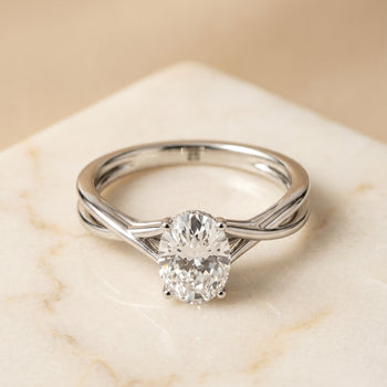 The Grace Twisted Shank Hidden Halo Solitaire Oval Engagement Ring Setting in 18K White Gold
