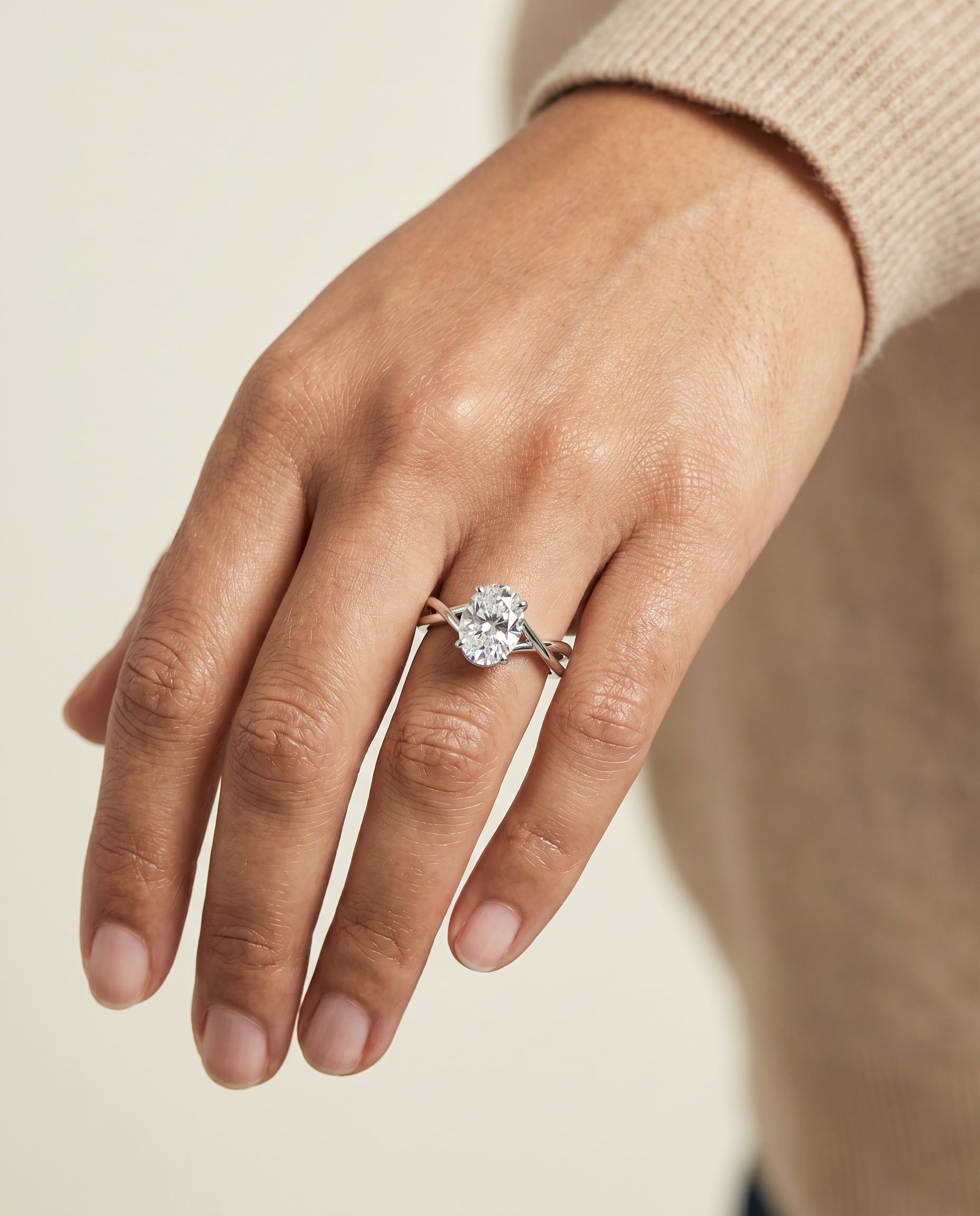 Grace Select Twisted Shank Hidden Halo Solitaire Oval Lab Diamond Engagement Ring in 18K White Gold, shown on hand | RockHer