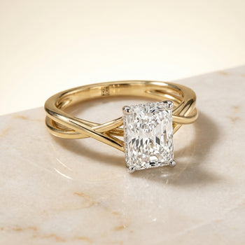 The Grace Twisted Shank Hidden Halo Solitaire Radiant Cut Engagement Ring Setting in 18K Yellow Gold