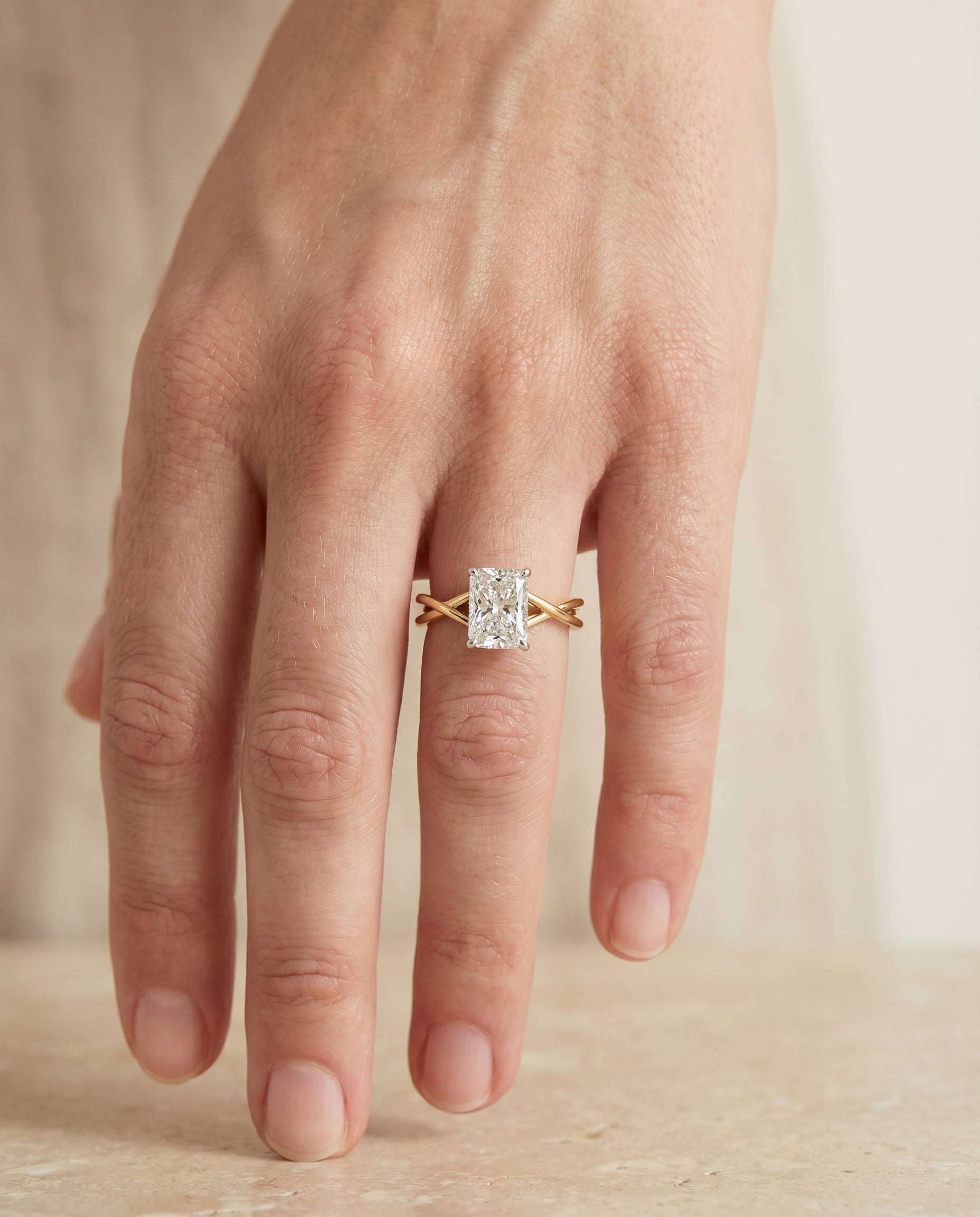 The Grace engagement ring setting in 18K Yellow Gold, twisted shank hidden halo solitaire cut design | RockHer