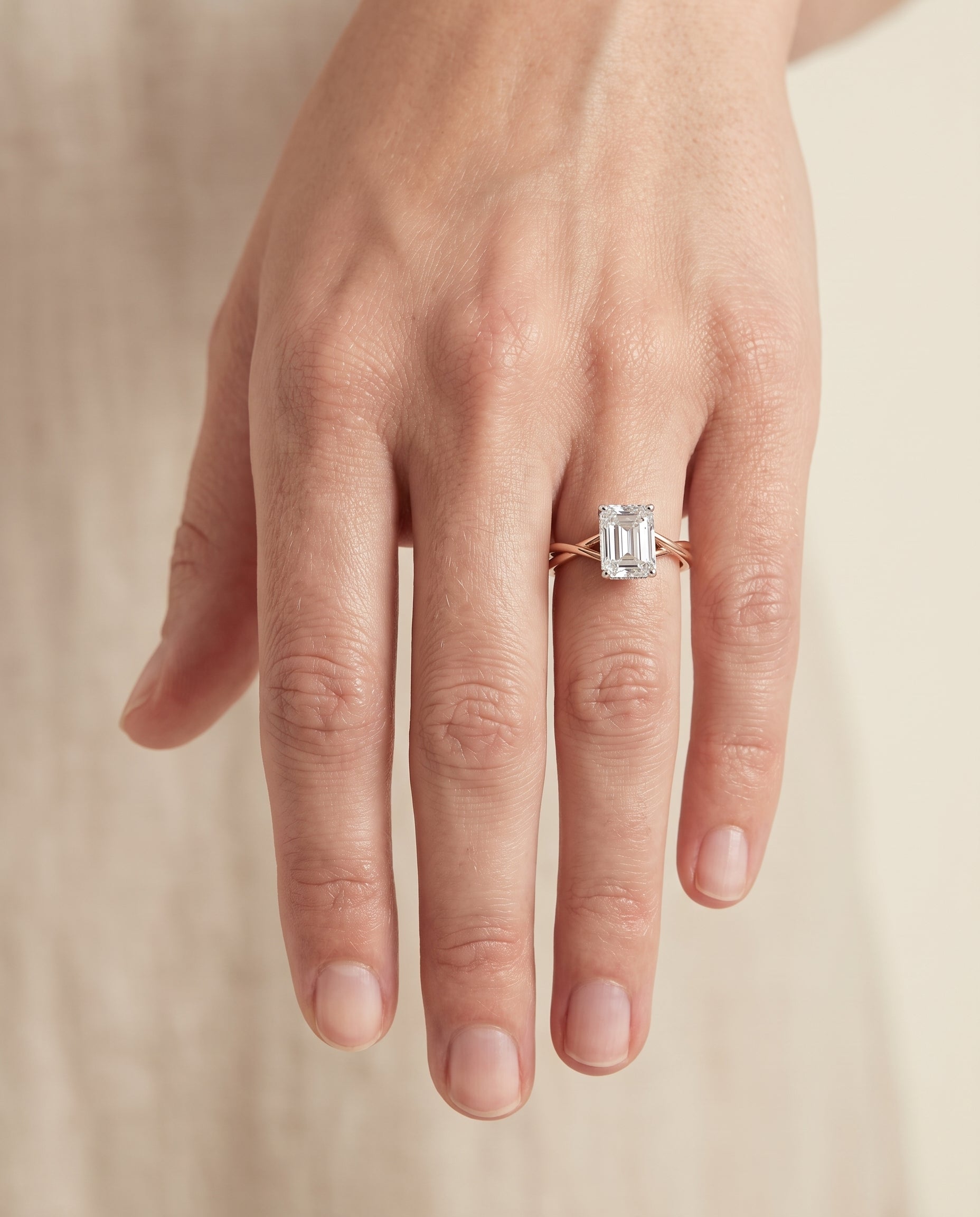 The Grace engagement ring setting in 14K Rose Gold, twisted shank hidden halo solitaire cut design | RockHer