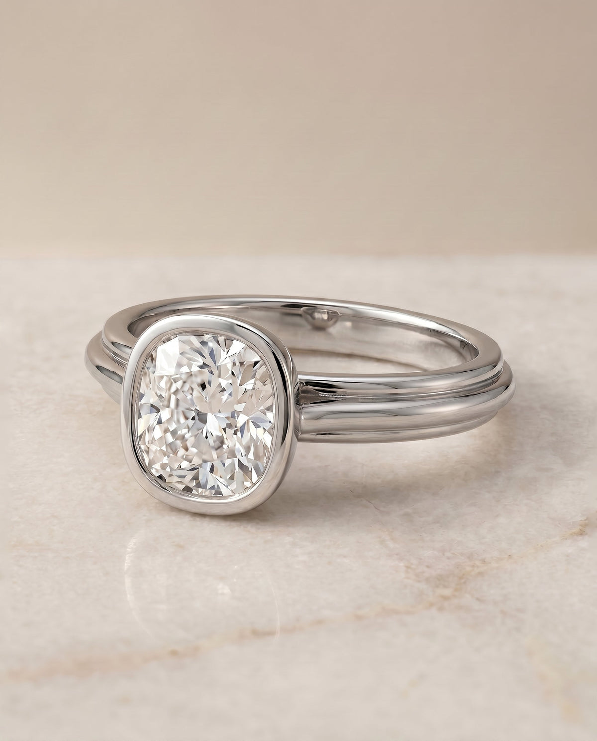 Hayley Select Bezel Solitaire Cushion Cut Lab Diamond Engagement Ring in Platinum, shown on hand, angled | RockHer