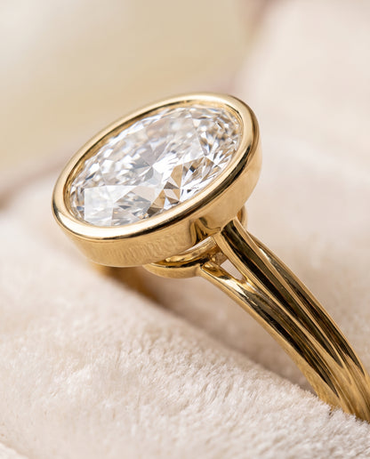 The Hayley Bezel Cathedral Solitaire Oval Engagement Ring Setting in 18K Yellow Gold