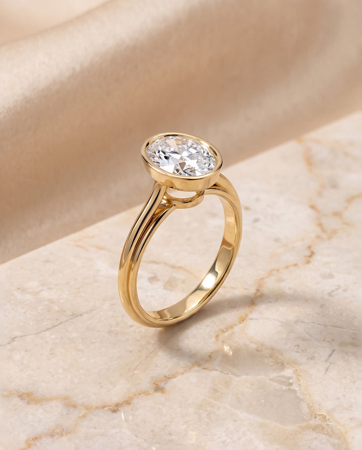 The Hayley Bezel Cathedral Solitaire Oval Engagement Ring Setting in 18K Yellow Gold