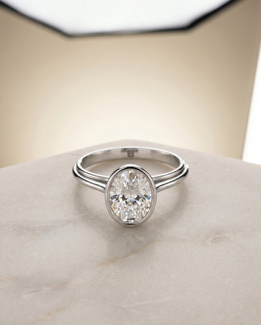 The Hayley Bezel Solitaire Engagement Ring Setting for Oval Diamonds in Platinum