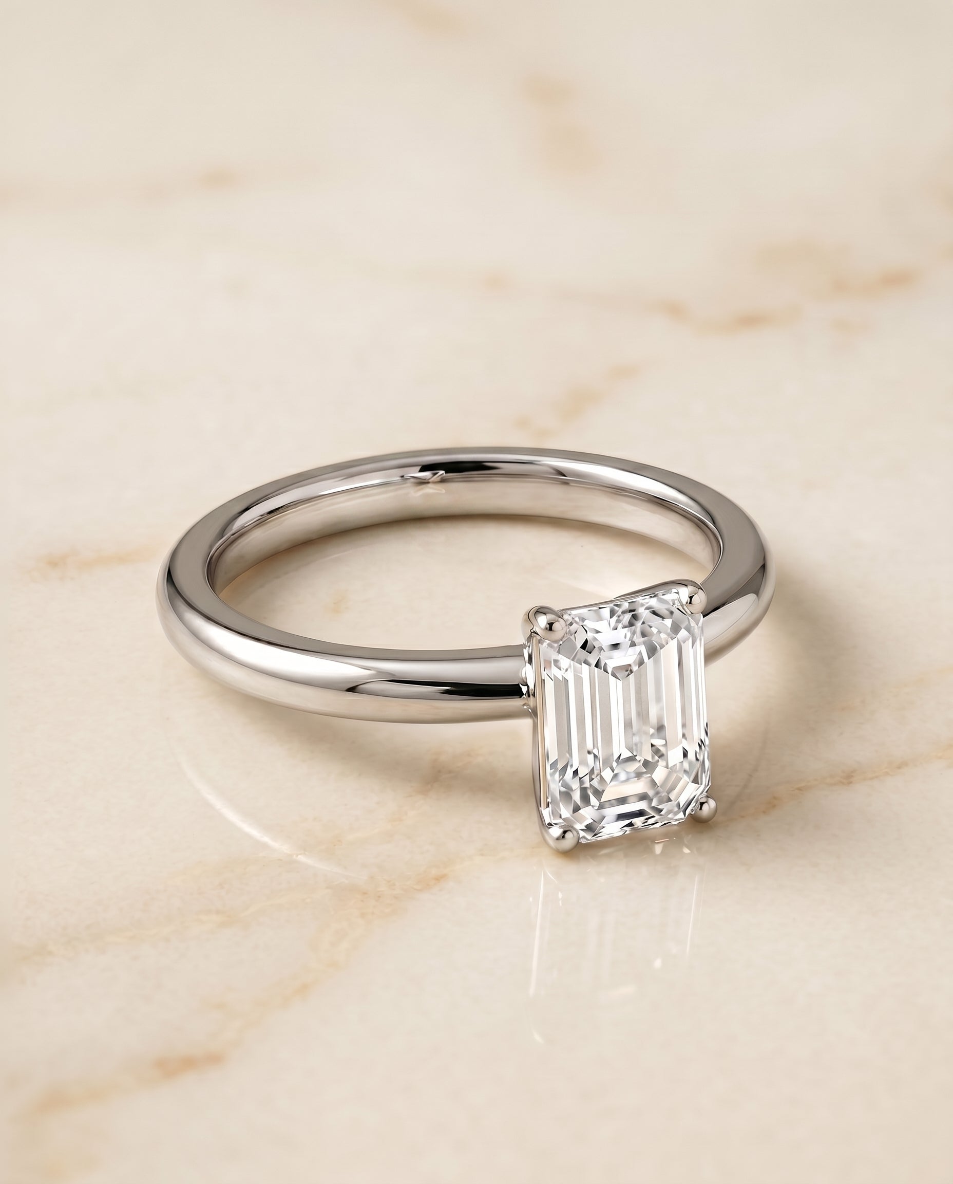 Isolde Select Knife Edge Solitaire Emerald Cut Lab Diamond Engagement Ring in Platinum, shown on hand, angled | RockHer