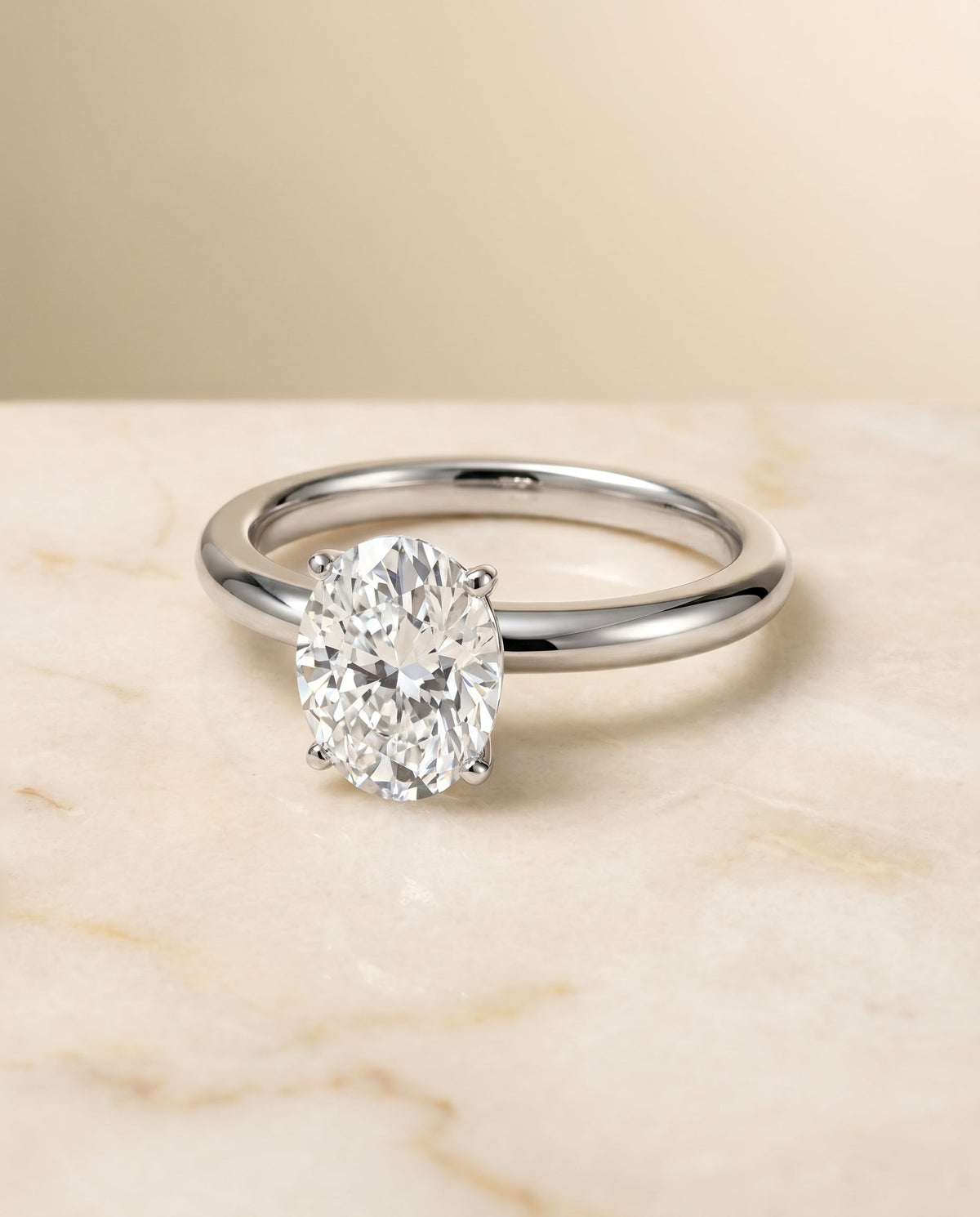 Isolde Select Knife Edge Solitaire Oval Lab Diamond Engagement Ring in 18K White Gold, shown on hand, angled | RockHer