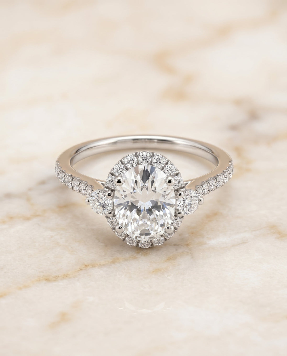 Ivy Select Three Stone Delicate Halo Oval Lab Diamond Engagement Ring in 18K White Gold, alternate angle | RockHer