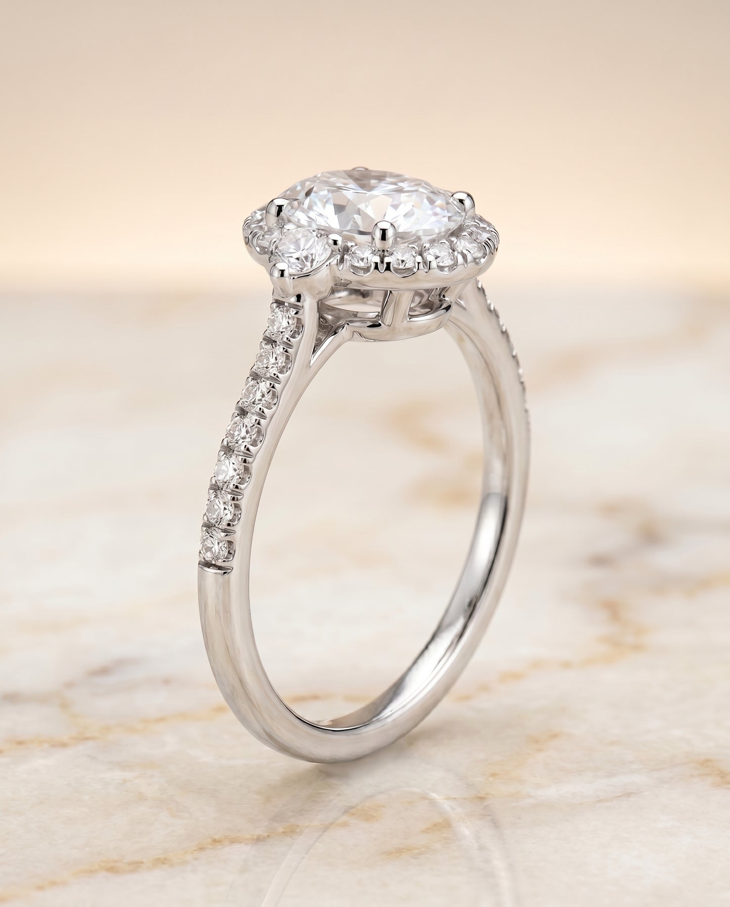 Three Stone Delicate Halo Oval, in Platinum – front view | RockHer