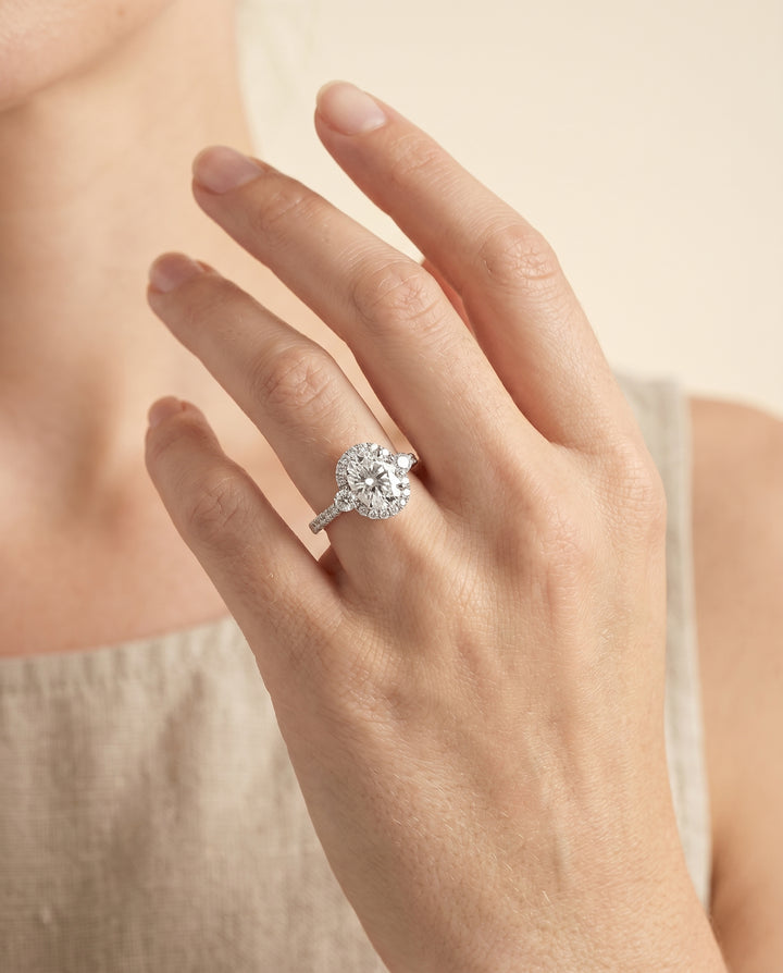 Three Stone Delicate Halo Oval, in Platinum – lifestyle shot | RockHer
