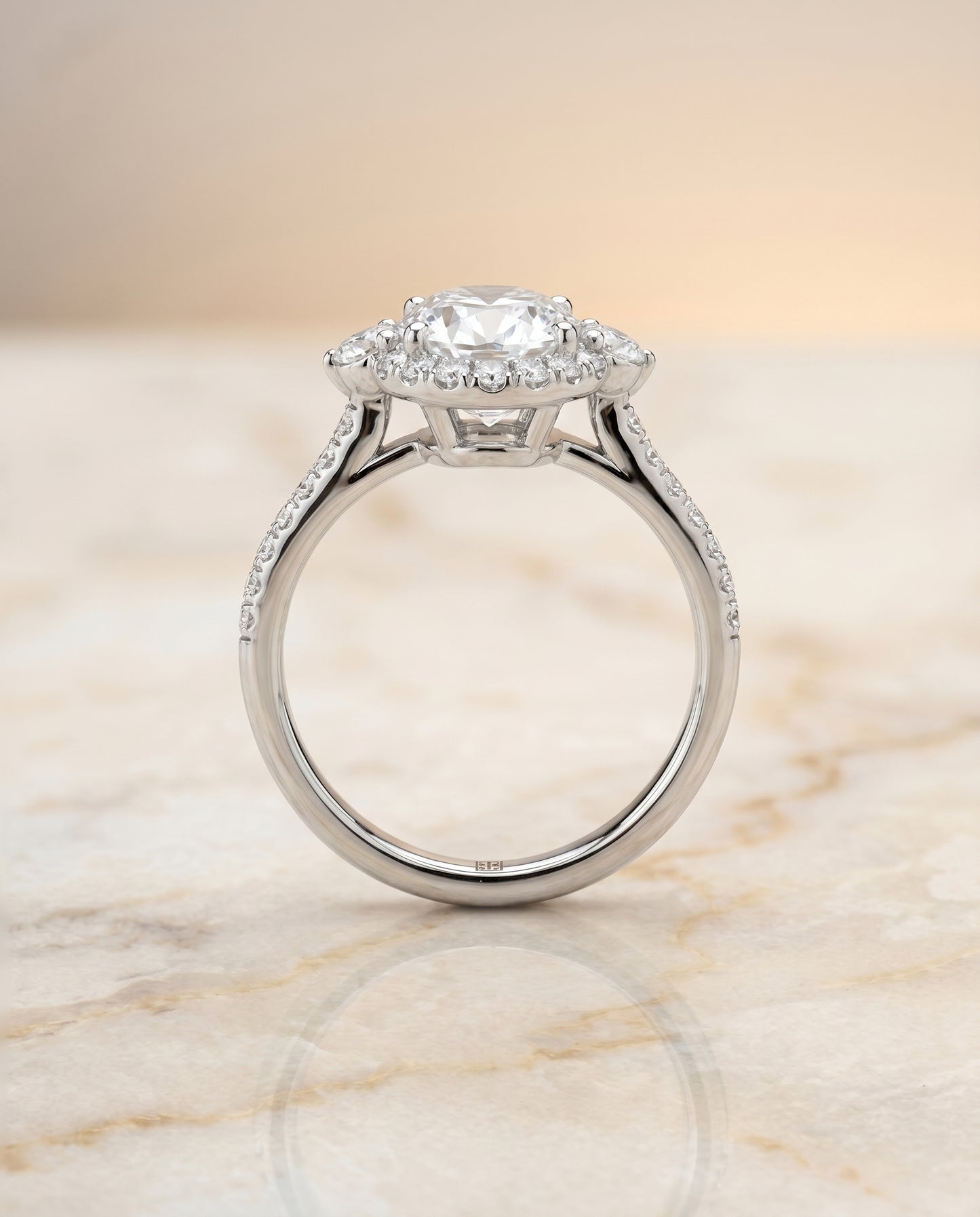 Three Stone Delicate Halo Oval, in Platinum – side profile | RockHer