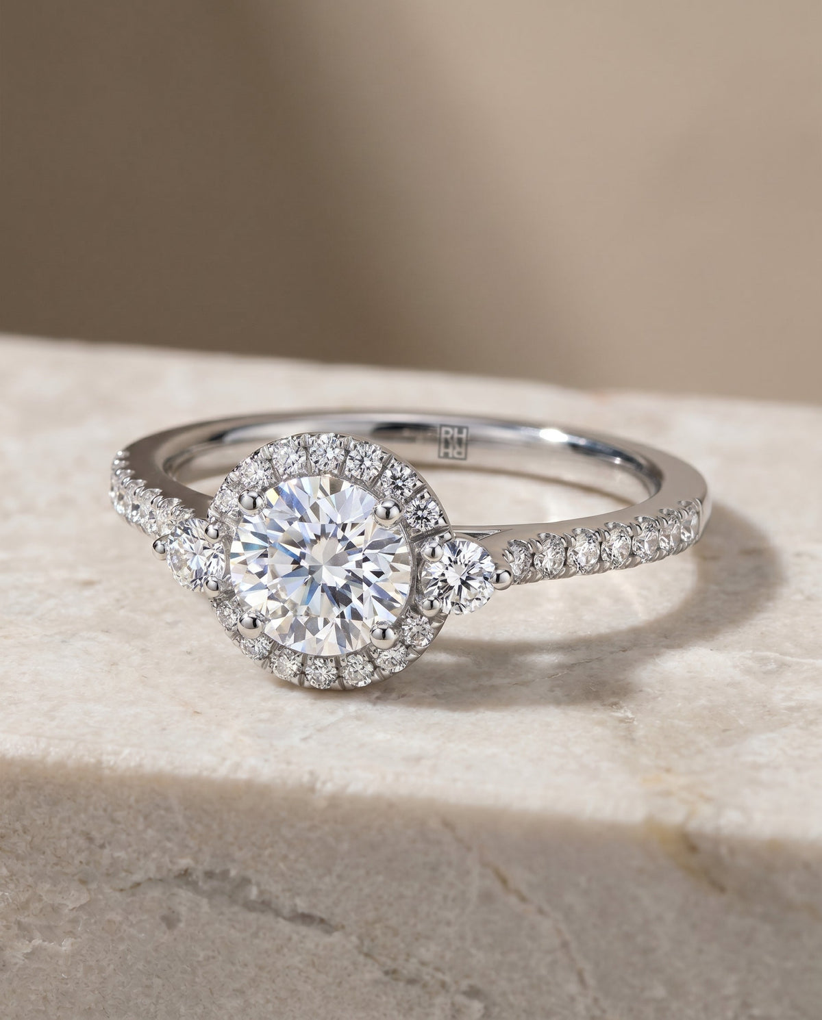 Ivy Select Halo Round Lab Diamond Engagement Ring in Platinum, shown on hand, angled | RockHer