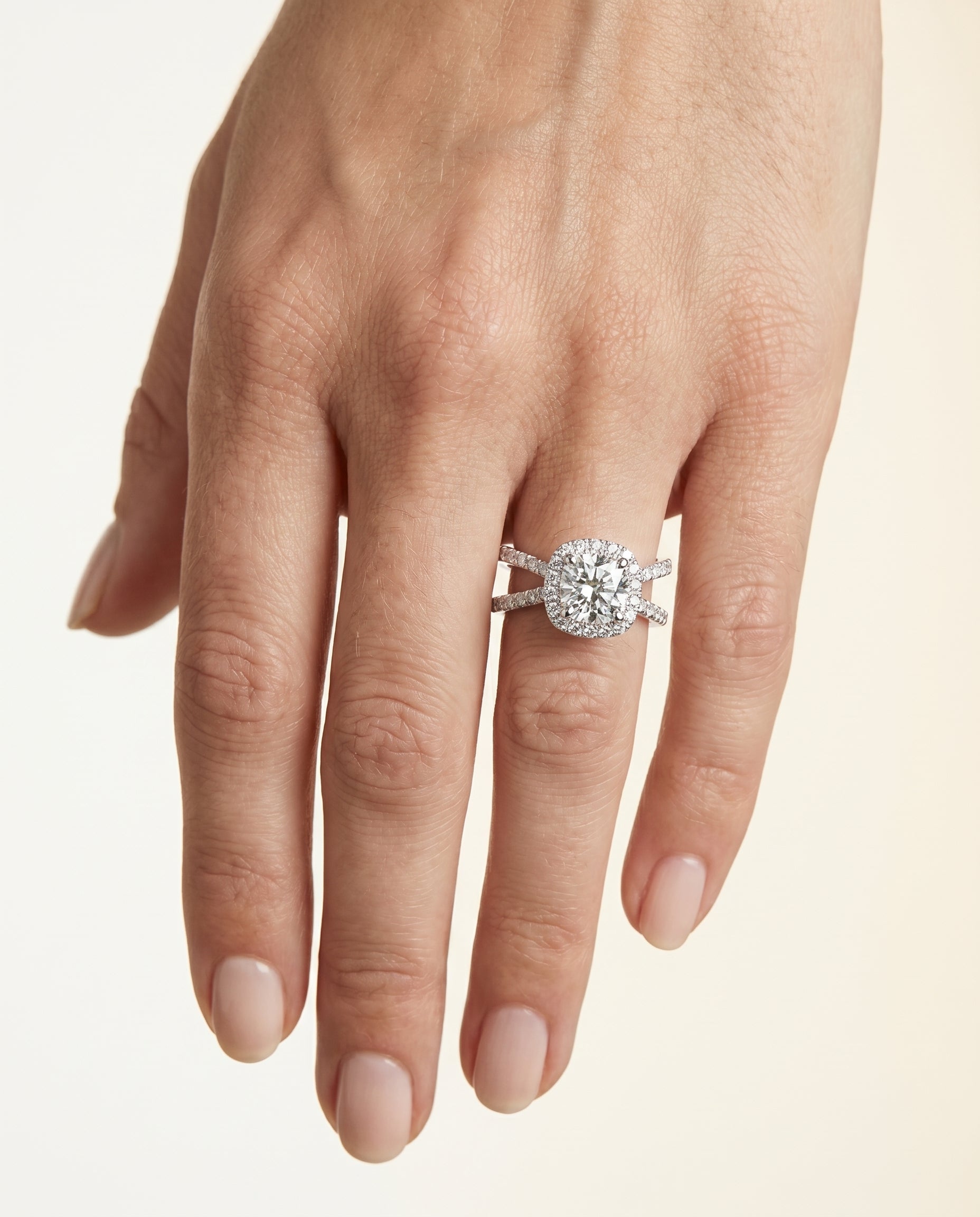 Joan Select Crossover Pavé Halo Cushion Cut Lab Diamond Engagement Ring in 18K White Gold, shown on hand | RockHer