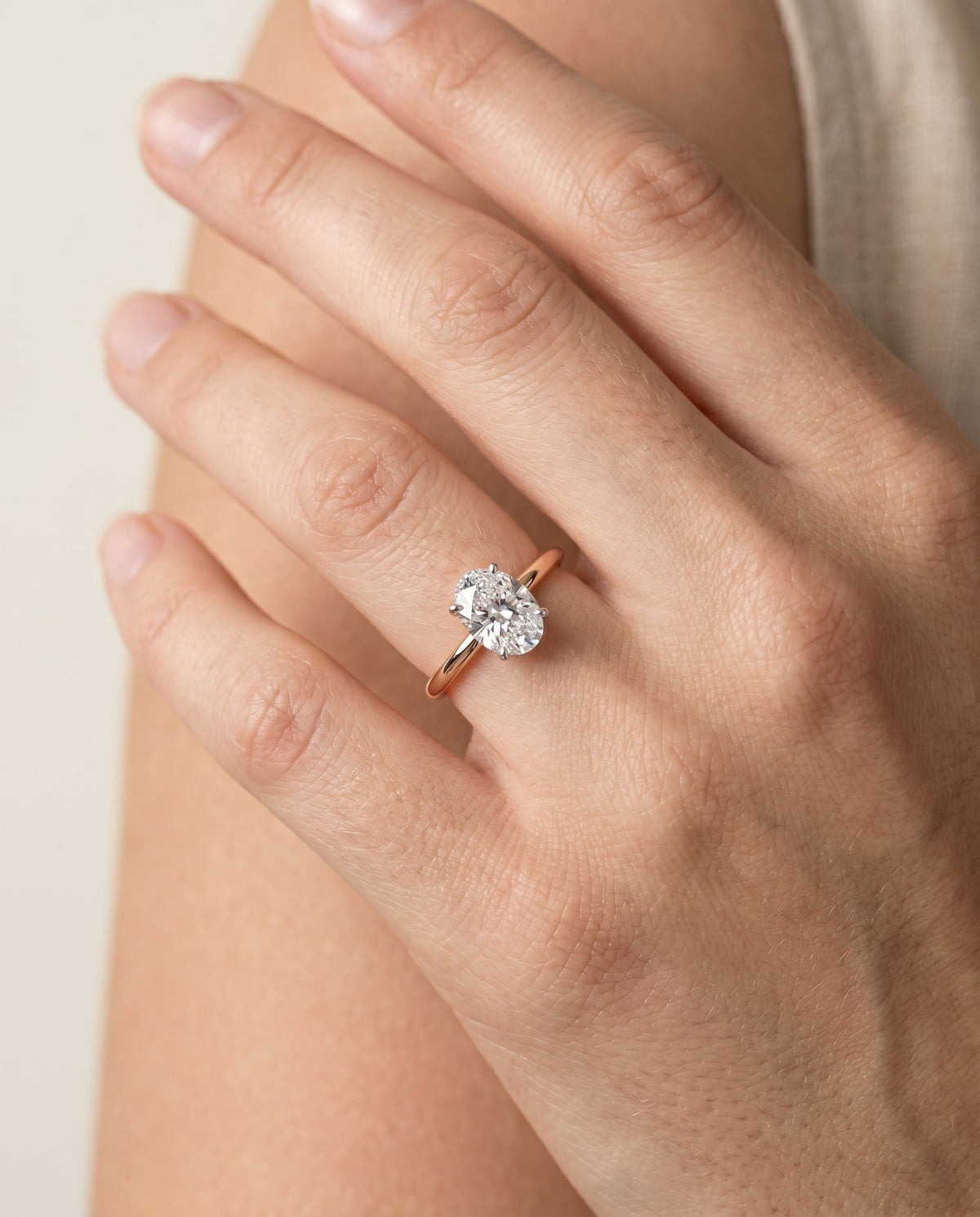 Joni Select Hidden Halo Oval Lab Diamond Engagement Ring in 14K Rose Gold, shown on hand | RockHer