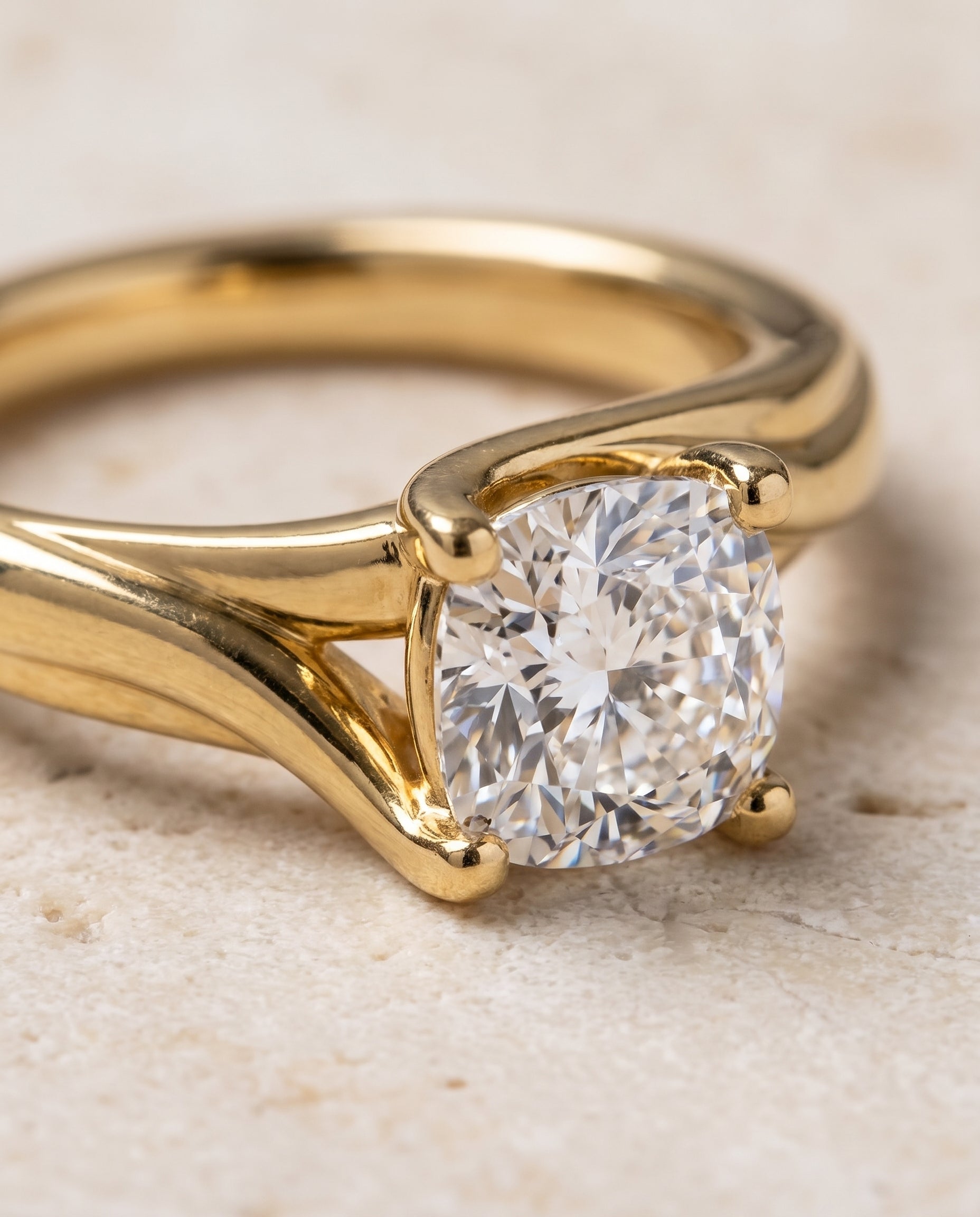 The Joplin Twisted Bypass Solitaire Cushion Cut Engagement Ring Setting in 18K Yellow Gold
