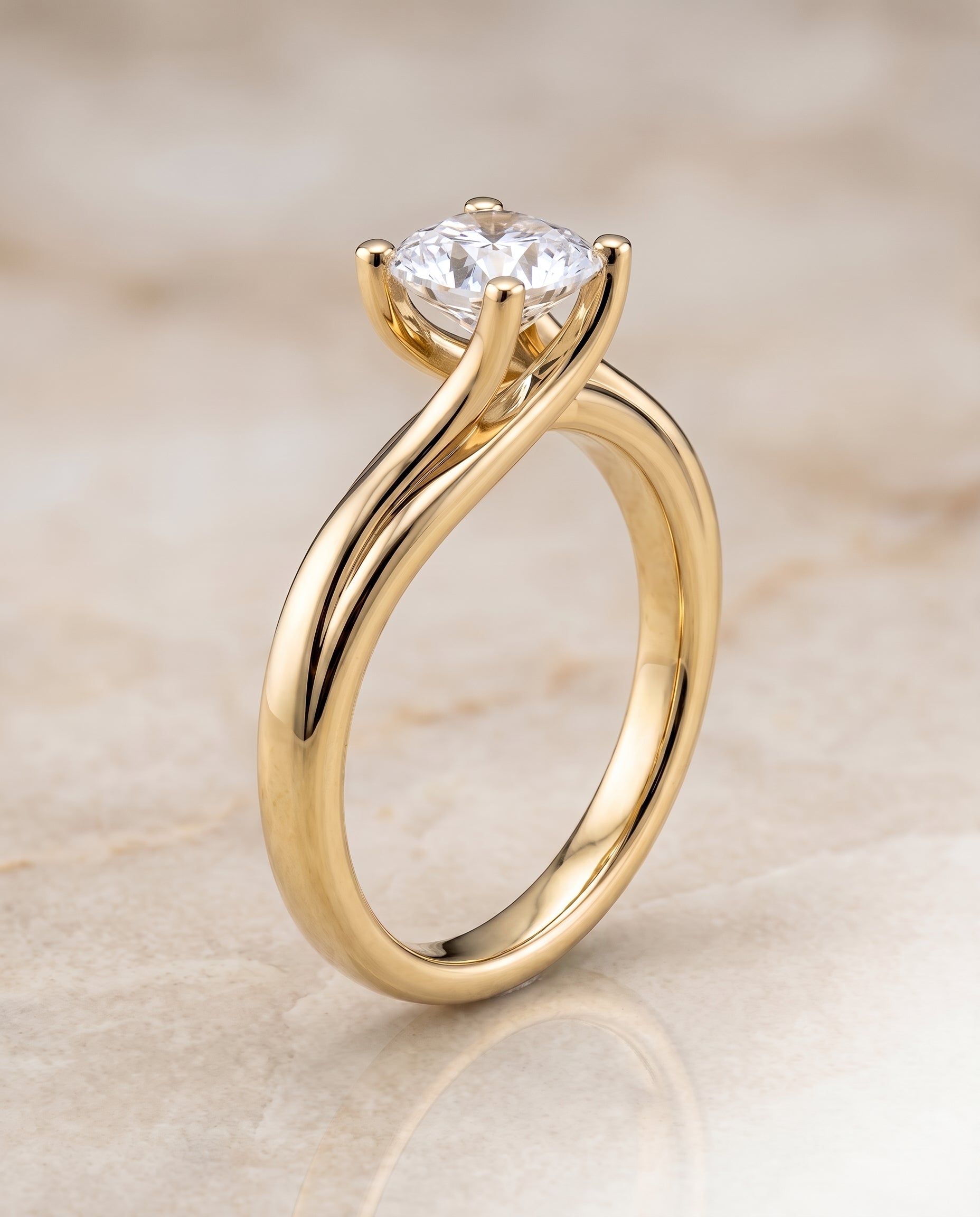 The Joplin Twisted Bypass Solitaire Cushion Cut Engagement Ring Setting in 18K Yellow Gold