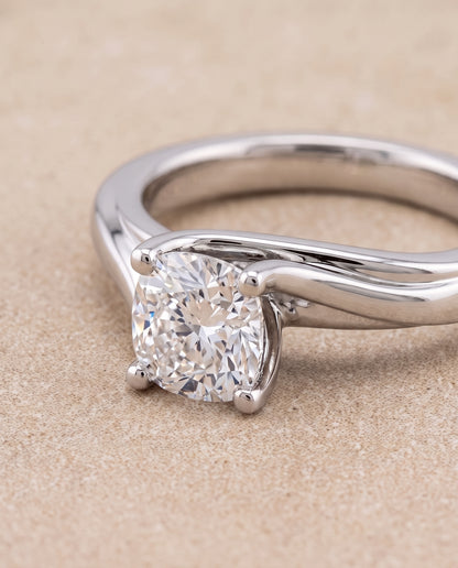 The Joplin Twisted Bypass Solitaire Cushion Cut Engagement Ring Setting in Platinum