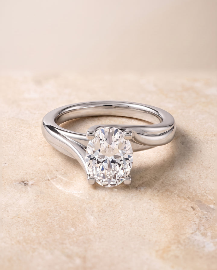 The Joplin Twisted Bypass Solitaire Oval Engagement Ring Setting in 18K White Gold