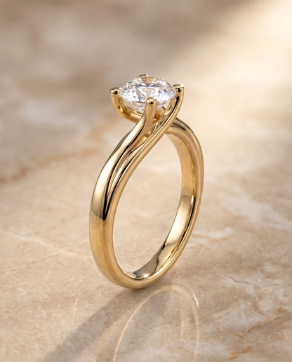 The Joplin Twisted Bypass Solitaire Round Engagement Ring Setting in 18K Yellow Gold