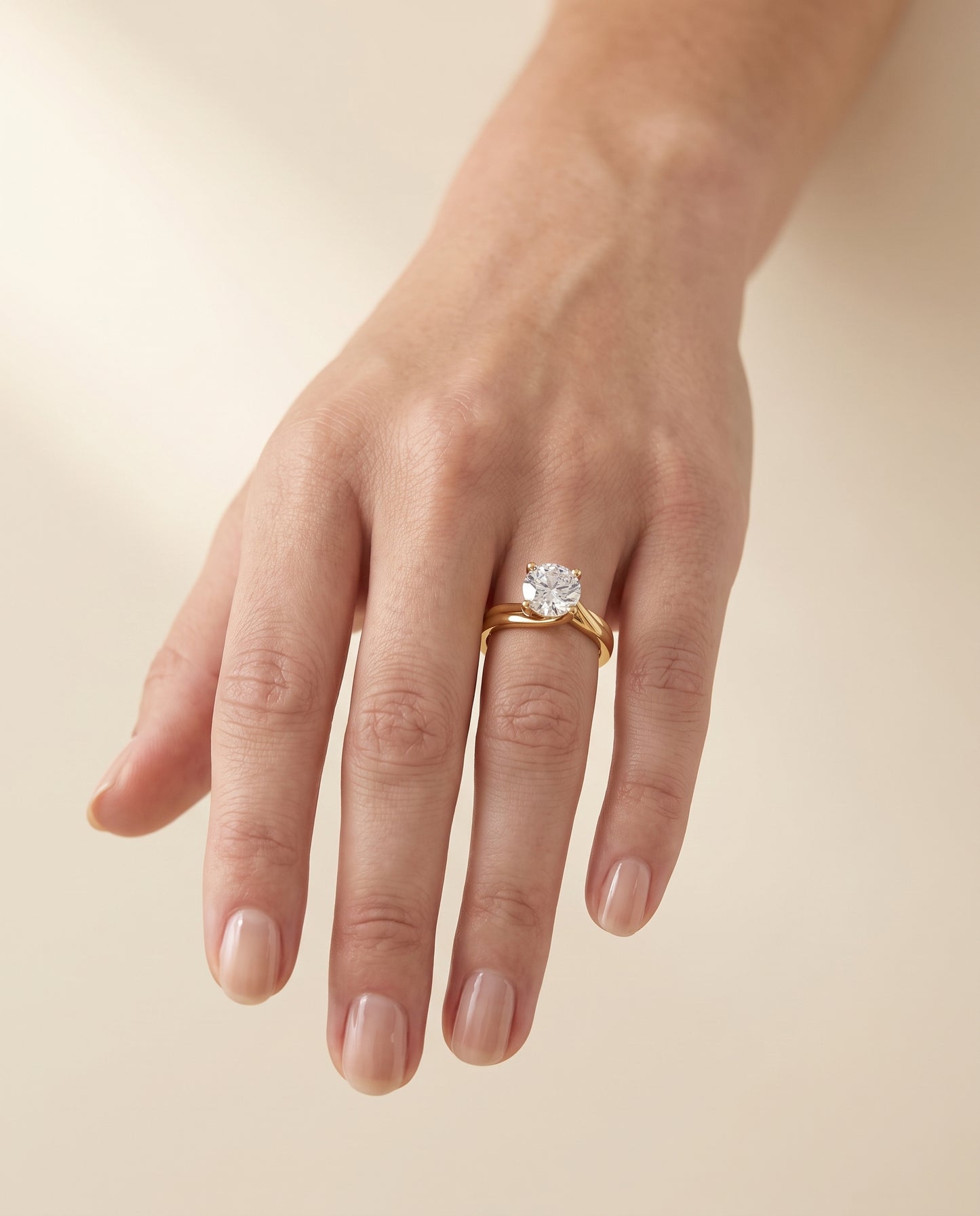 The Joplin Twisted Bypass Solitaire Round Engagement Ring Setting in 18K Yellow Gold