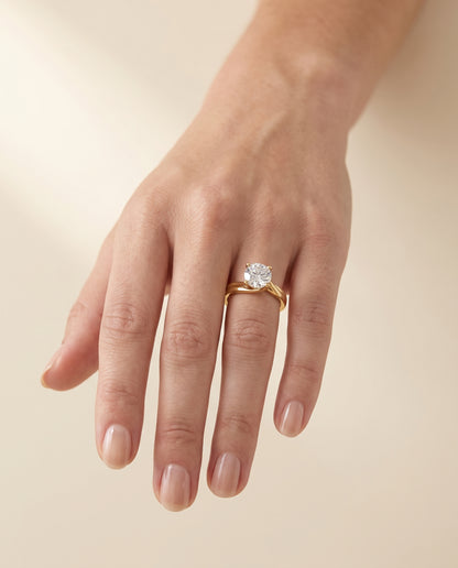 The Joplin Twisted Bypass Solitaire Round Engagement Ring Setting in 18K Yellow Gold
