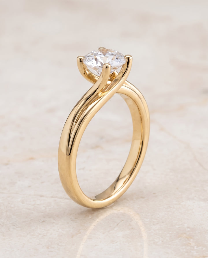 The Joplin Twisted Bypass Solitaire Round Engagement Ring Setting in 18K Yellow Gold