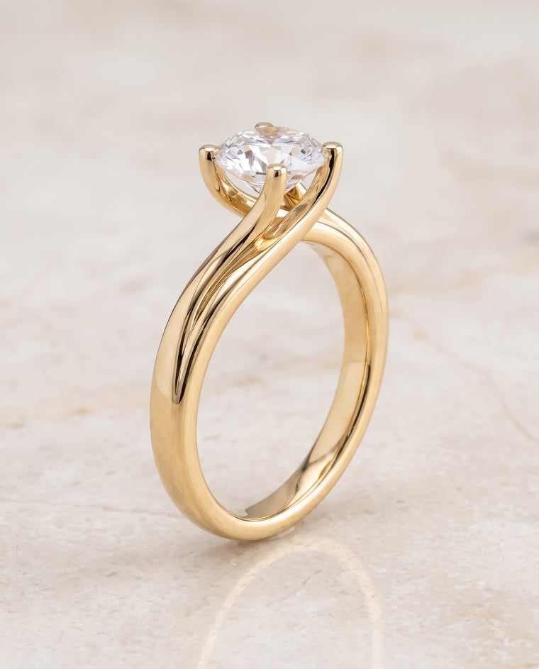 The Joplin Twisted Bypass Solitaire Round Engagement Ring Setting in 18K Yellow Gold