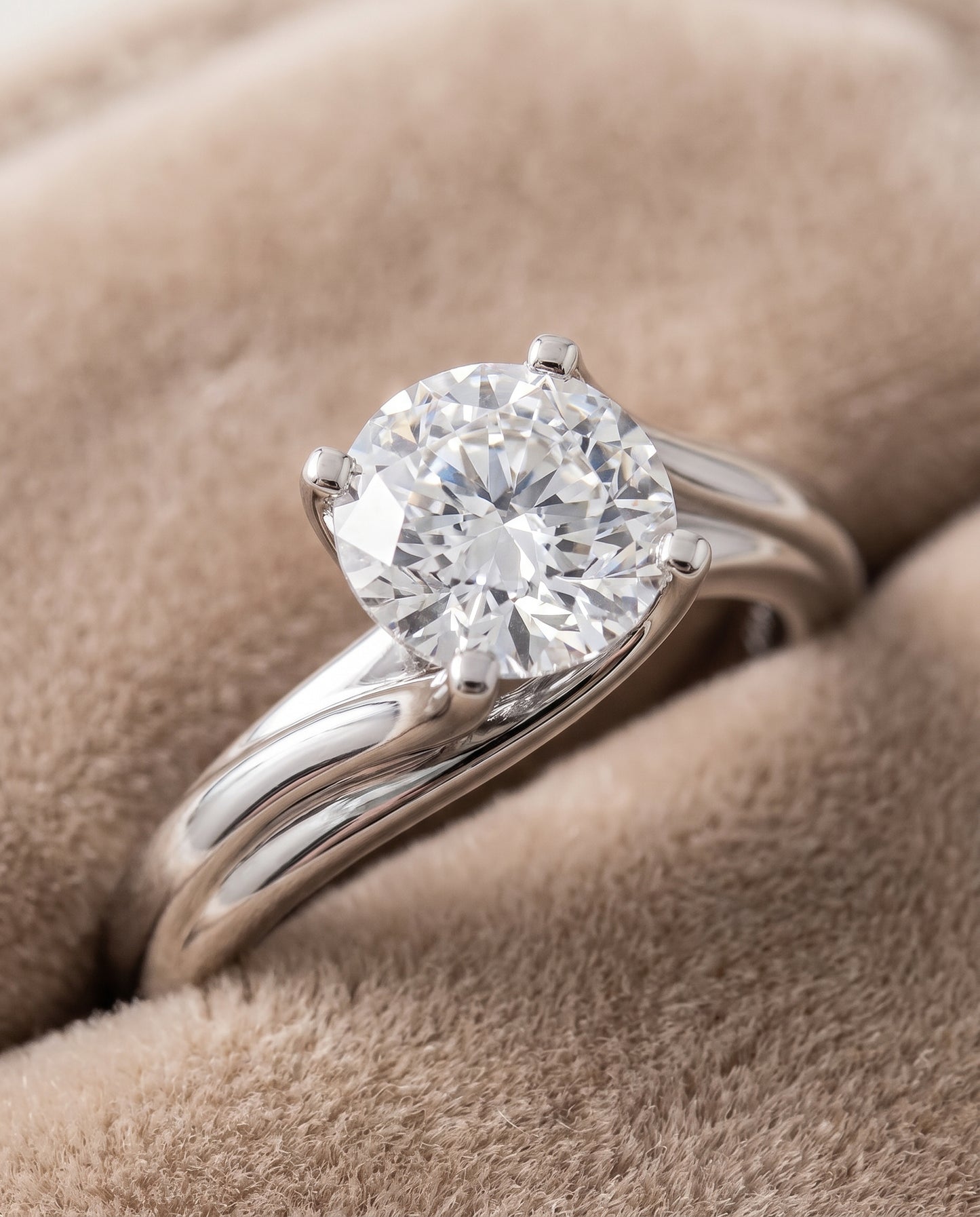 The Joplin Twisted Bypass Solitaire Round Engagement Ring Setting in 18K White Gold