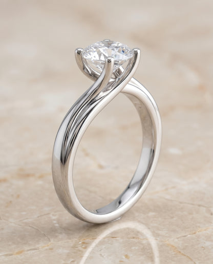 The Joplin Twisted Bypass Solitaire Round Engagement Ring Setting in 18K White Gold