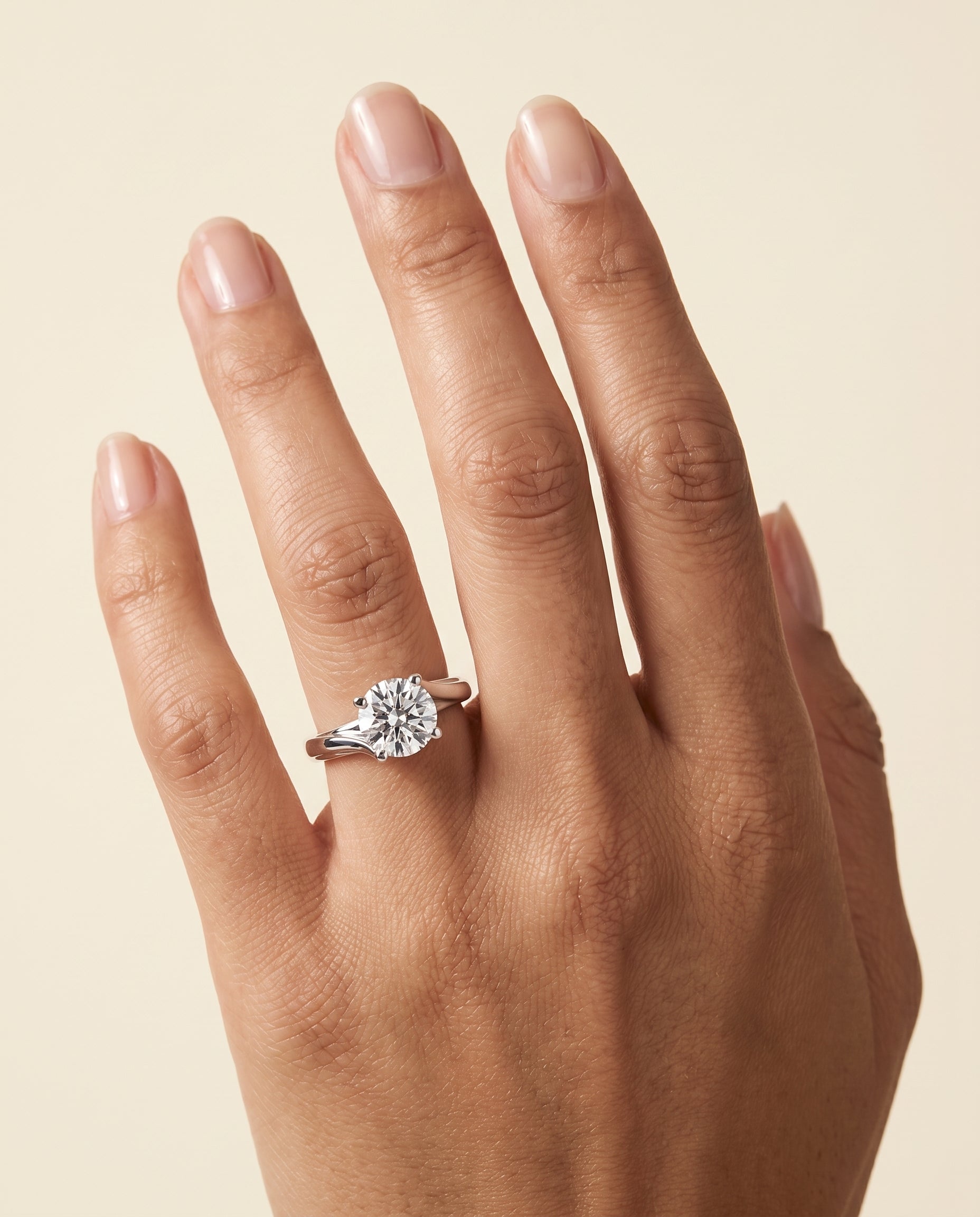 The Joplin Twisted Bypass Solitaire Round Engagement Ring Setting in 18K White Gold
