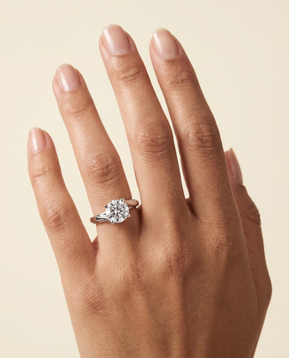 The Joplin Twisted Bypass Solitaire Round Engagement Ring Setting in 18K White Gold