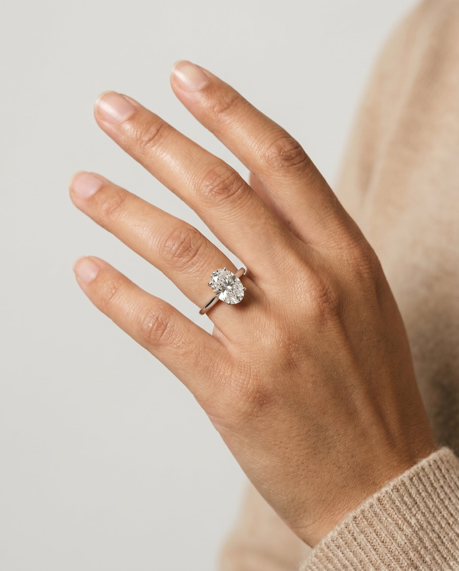 Juliette Select Cathedral Solitaire Oval Lab Diamond Engagement Ring in Platinum, shown on hand | RockHer