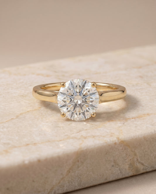 The Juliette Solitaire Engagement Ring Setting for Round Diamonds in 18K Yellow Gold