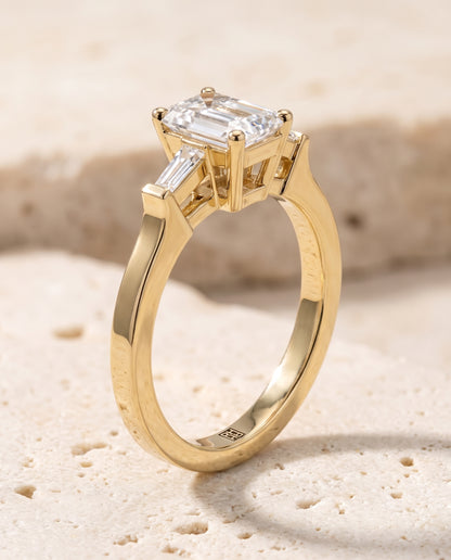 The June Three Stone Emerald Cut Engagement Ring Setting in 18K Yellow Gold