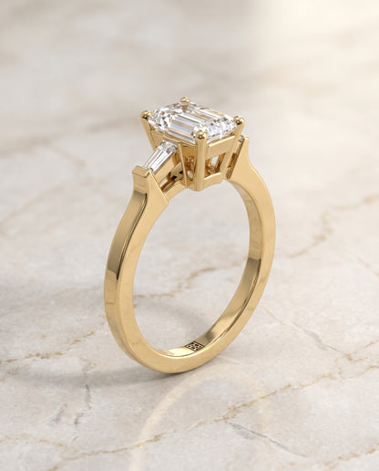 The June Three Stone Emerald Cut Engagement Ring Setting in 18K Yellow Gold