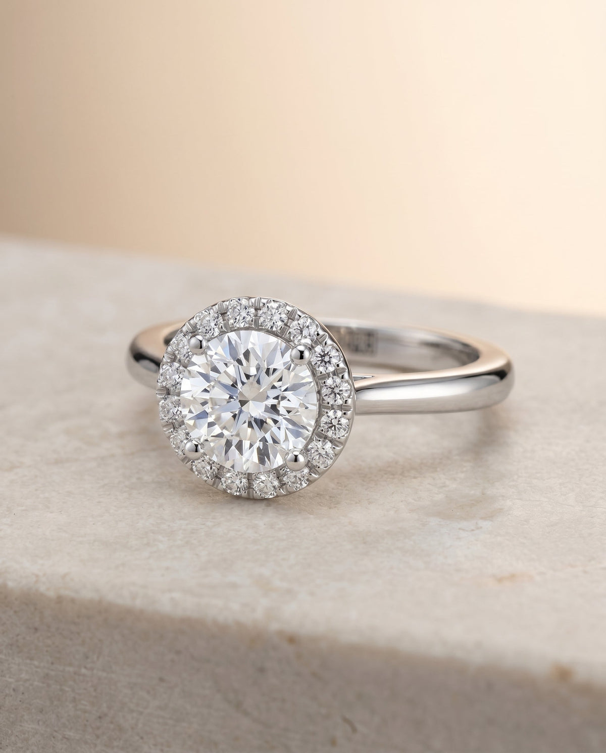 Kate Select Halo Round Lab Diamond Engagement Ring in Platinum, shown on hand, angled | RockHer